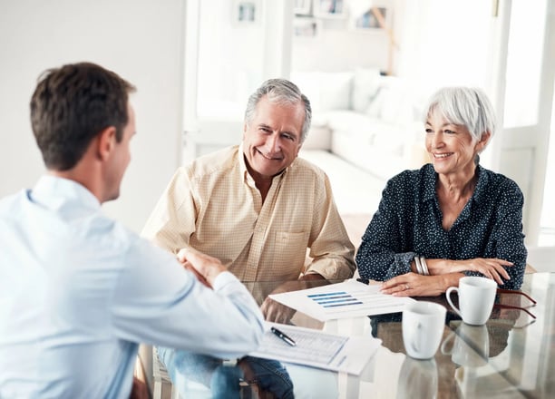 Senior couple meeting with an estate planning advisor to secure their legacy with Guarded Legacy.