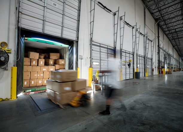 Loading a 26ft box truck at a loading dock in a business with a pallet jack.