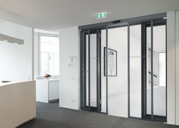 a office with a large glass door and a counter