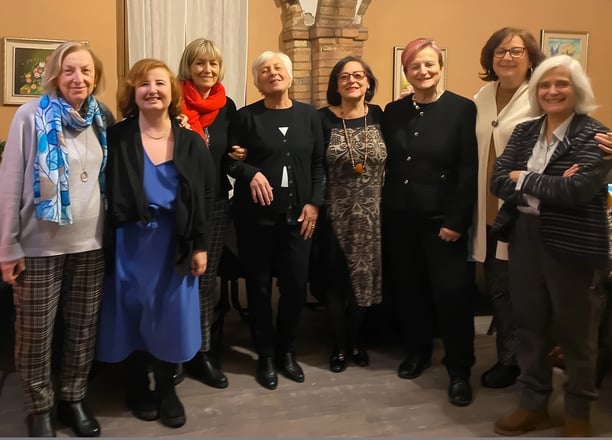 a group of women standing in a room