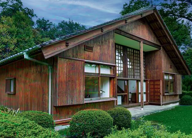 Photo of house with dark wooden trim and a metal roof.