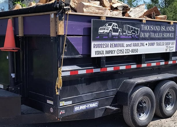 A dump trailer loaded with split firewood