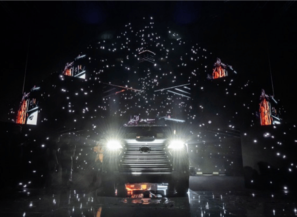 A car launch event featuring dynamic lighting, digital visuals, and an intricate stage design with a