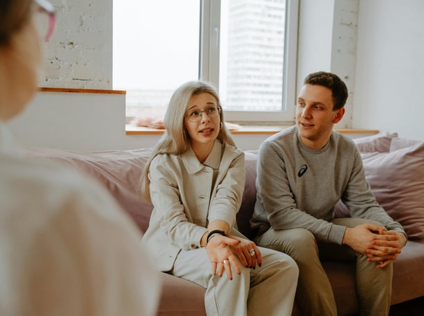 a man and woman sitting on a couch