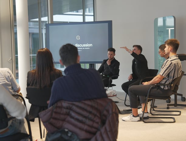 a group of people sitting in chairs in a room