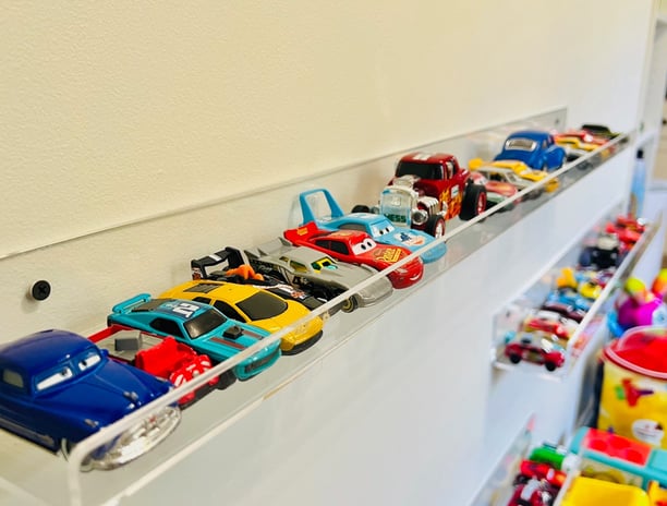 a collection of toy cars on display in a room