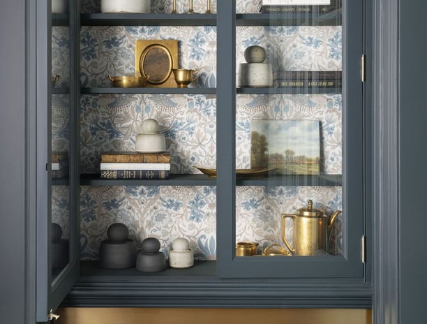a cabinet with a glass door and a shelf with dishes