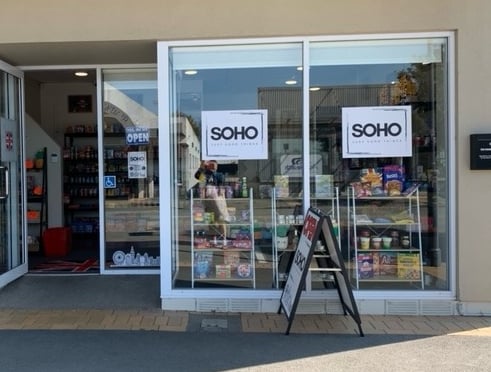 a store front door of a store with a sign that says soho