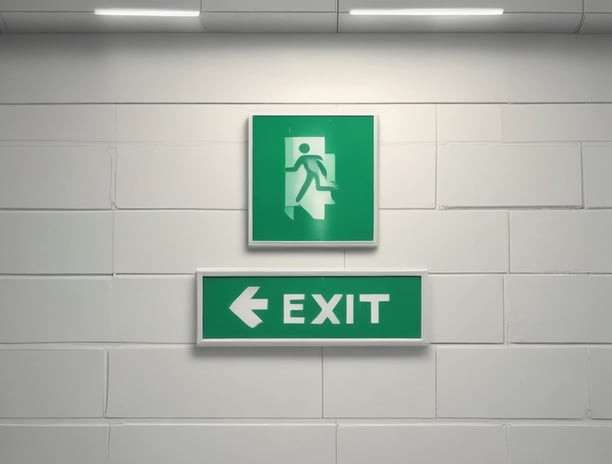 A dark, industrial-style fire safety door is set into a textured concrete wall. The door is equipped with a simple handle and features a sign that states 'Fire Safety Door - Do Not Obstruct - Do Not Keep Open.' Above the door, a small white box is mounted on the wall, possibly an alarm or sensor.