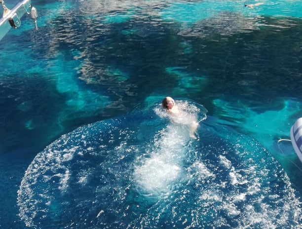 swimming in a quiet cove while sailing from kefalonia