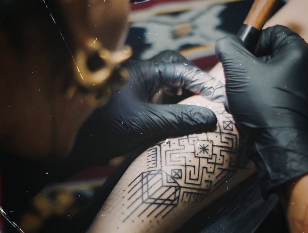 An handpoke tattoo artist with close up need,e tattoing 