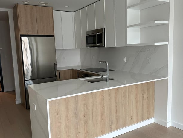 a kitchen with a large island style counter top