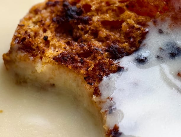 Crunchy, moist bread and butter pudding with crème anglaise, infused with cinnamon and nutmeg