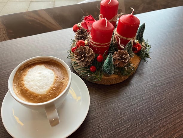 a cup of coffee with a candle on a table