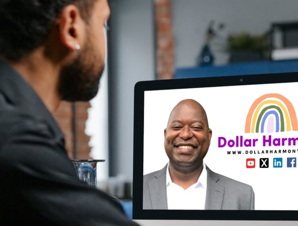 a man sitting at a computer screen looking at his Dollar Harmony Coach and a colored rainbow