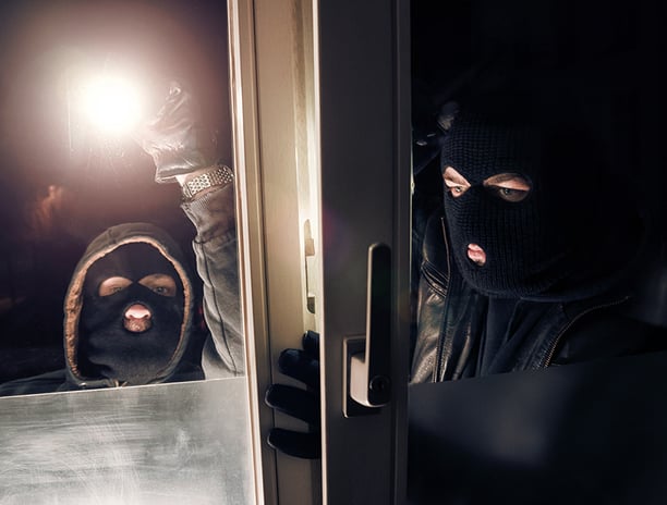 two burglars breaking into a residential homes unlocked window