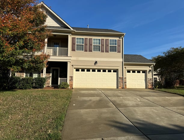 a house with a garage door and a driveway