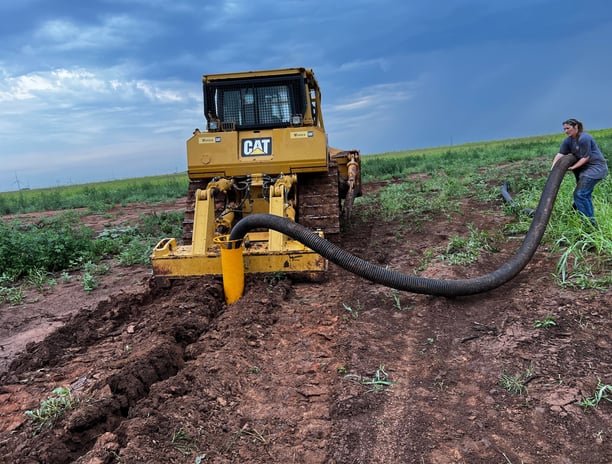 CAT D8T plowing in drain tile