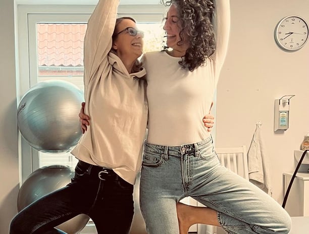 a woman doing yoga poses with a man