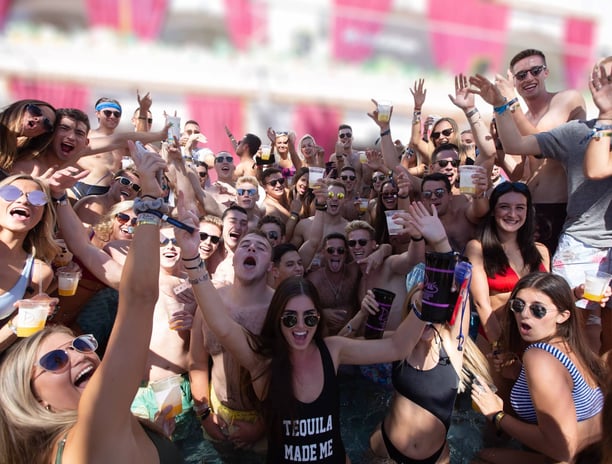High-energy crowd partying at a Las Vegas dayclub during a poolside crawl