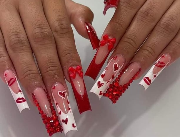 a woman's hands with red and white hearts on them