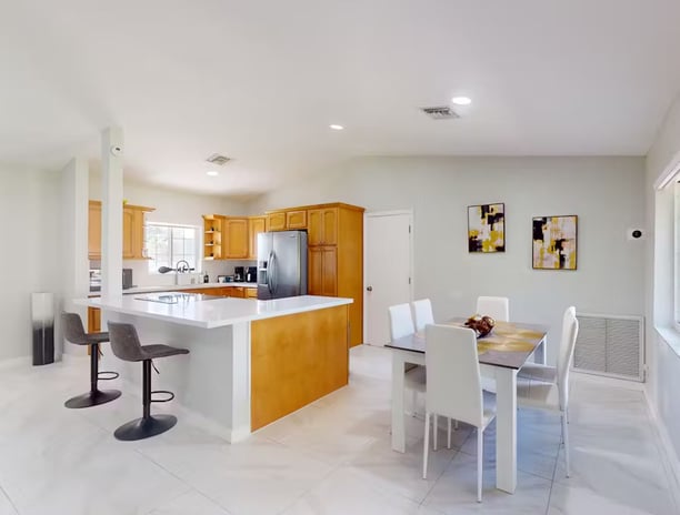 a kitchen with a table and chairs and a table