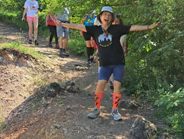 woman in running clothes ahead of other runners
