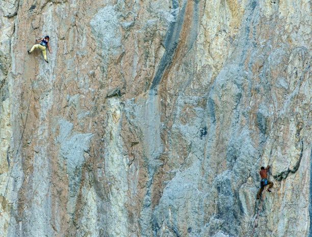 a man climbing a steeple on a mountain