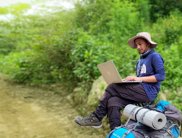 This image captures our founder working for a client while traveling through the mountains