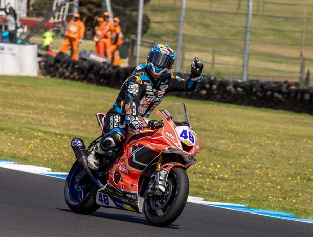 a person riding a motorcycle on a track