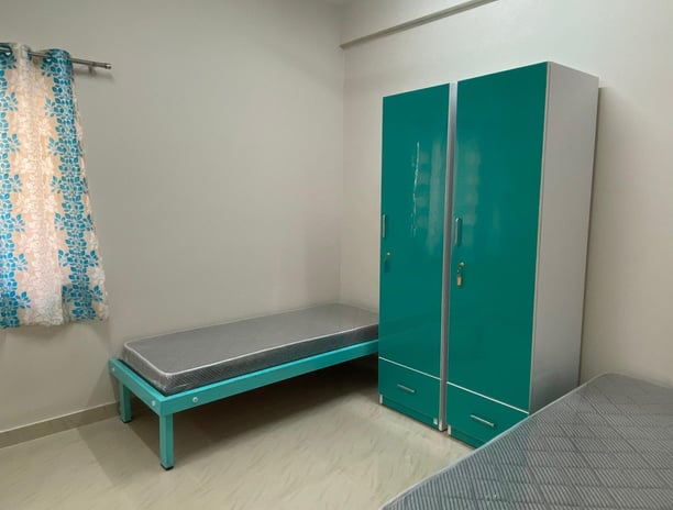 Spacious twin-sharing PG room in Banglore with a modern furniture, A/C and luxury.