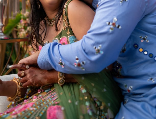 a man and woman in a colorful dress and a man in a blue suit