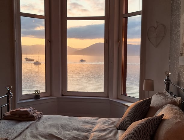 The bed at Gourock Seaview Holiday Let with the bed and a view of the sea