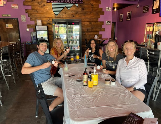 a group of people sitting at a table with drinks