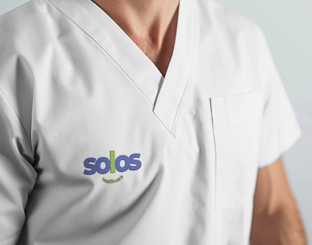A healthcare uniform with the Solos logo on