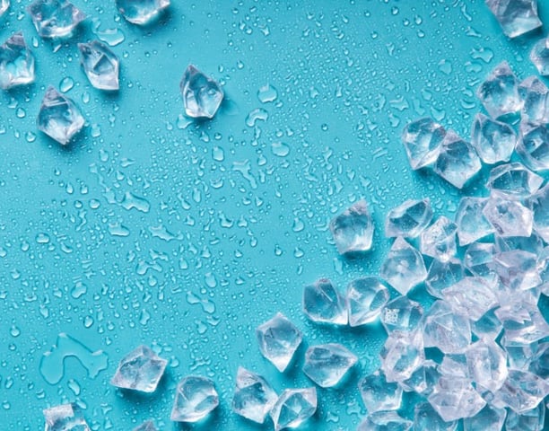 a bunch of ice cubes on a blue background