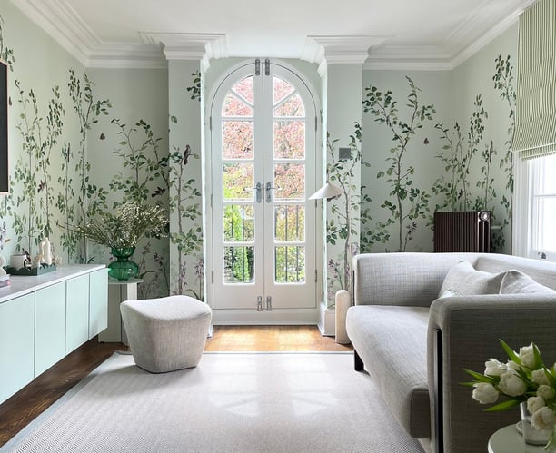 green vine floral wallpaper with green painted walls and neutral living room