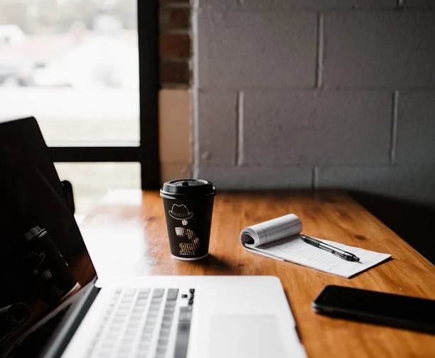 Image of a writing desk with coffee depicting BoldREcontent's book writing service