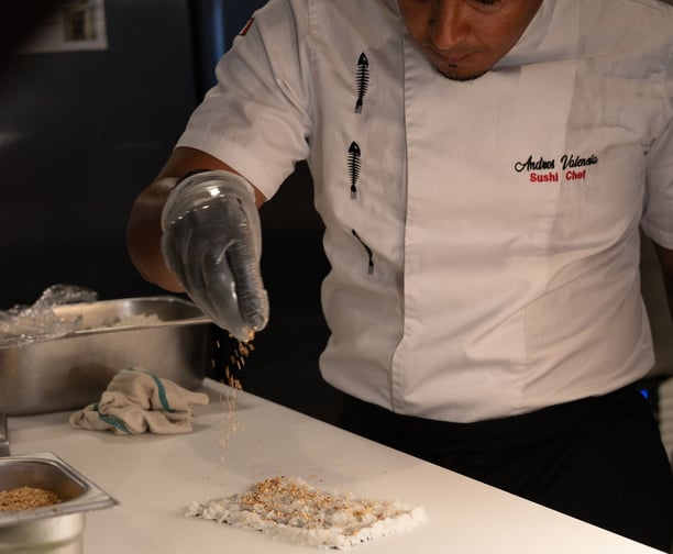 A professional sushi chef preparing a sushi roll at our Asian Fusion Bistro called Mr Chow.