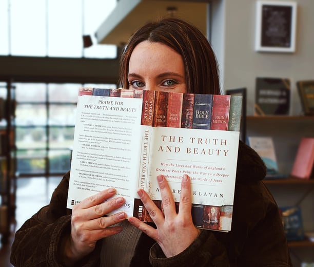 Ashleigh Marie model holding the book "The Truth and Beauty" in front of her face.