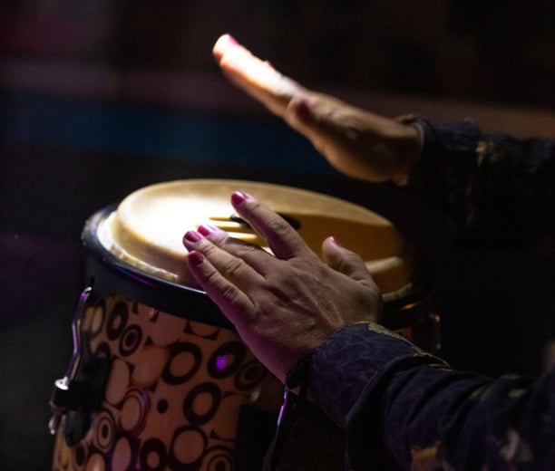 a person playing a drum drum in a room