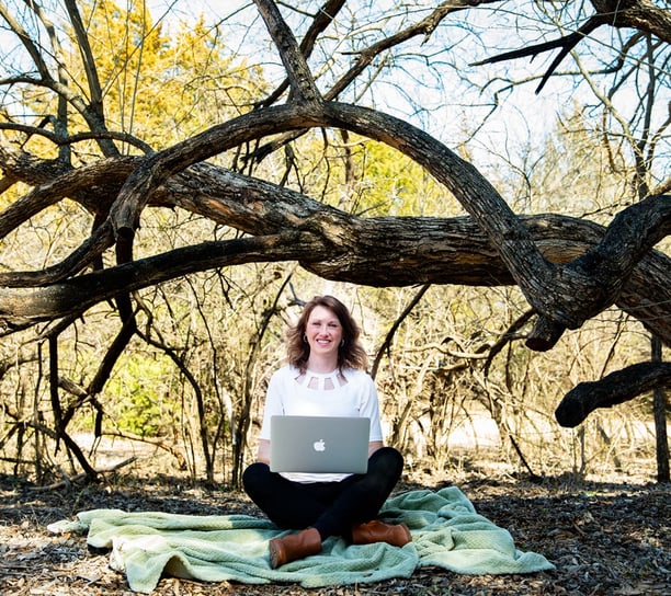 girl in nature with laptop