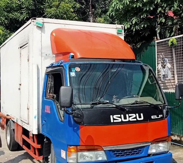 a truck with a trailer parked in front of a house