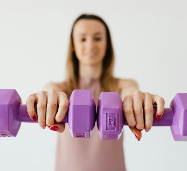 female adult lifting weights for exercise