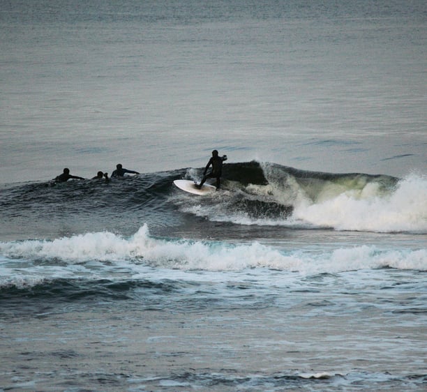 A surfer doing a top turn on a clean shoulder high wave