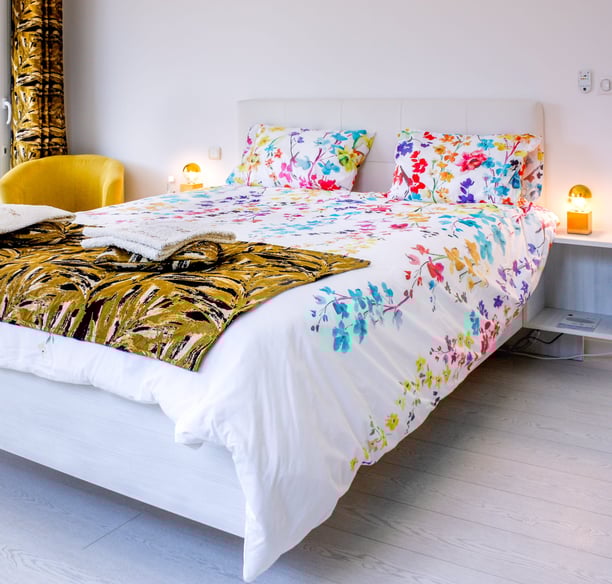 Bed with full bedding, floating bed with two with swimming pool in flower colours at Domaine Des Lucques