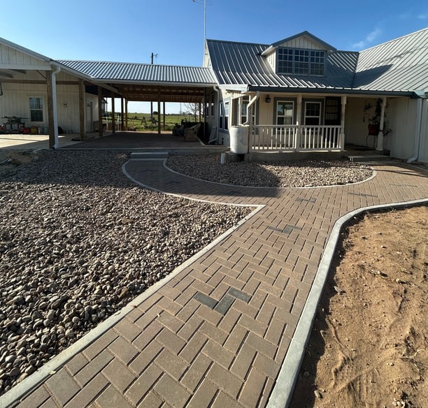 New roof with concrete porch and a custom paver walkway