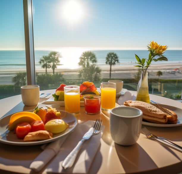 a table with a plate of food and a vase with flowers overlooking Kihei beach