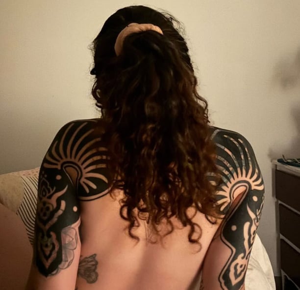a woman with tattoos on her back and a tattoo on her back tattoo Gap 05