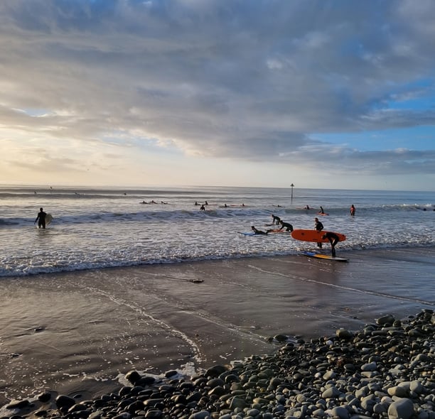 A busy surf lesson at Ynyslas with clean good waves  and evening sunshine